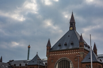 The upper part and roof of the train station in Copenhagen, Denmark. Cloudy moody sky background.