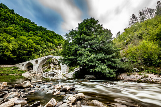 Thirty seconds long exposure with water motion blur at Devil's Bridge, Southern Bulgaria, scenery summer evening
