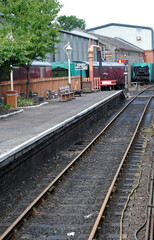 Fototapeta na wymiar View along Deserted Rails and Platform at Old Heritage Railway Station 