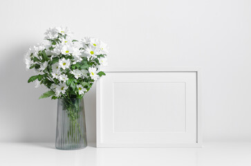 Landscape frame mockup in white minimalistic interior with flowers bouquet