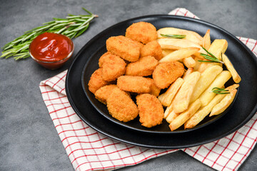 Chicken nuggets with potatoes french fries and ketchup