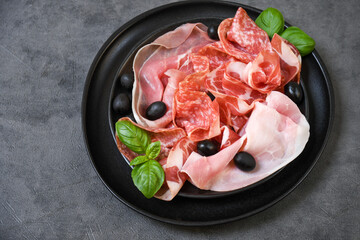 Food antipasti prosciutto ham, parma ham, salami, olives and bread. Charcuterie plate