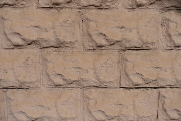 Close view of light brown painted brick veneer wall