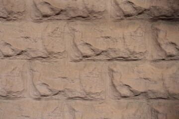 Closeup of painted light brown brick veneer wall