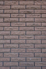 Dark brown brick veneer wall with black mortar joints