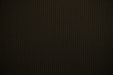 Abstract background made of corrugated paper for black application. Space for text. Texture. Vertical stripes.