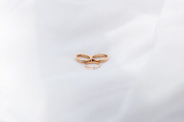 wedding gold rings on a white background. play of light and shadow. minimalism place for text