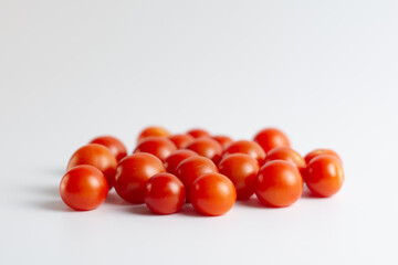 Fresh tasty red cherry tomatoes on white background