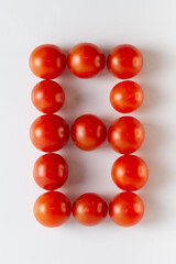 Number eight. A figure of cherry tomatoes on a white background. Tomatoes close-up. Tomatoes in the form of the Number eight