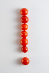 A figure of cherry tomatoes on a white background. Tomatoes close-up. Exclamation mark. 