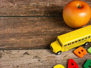 The school bus on wood table for back to school or education concept