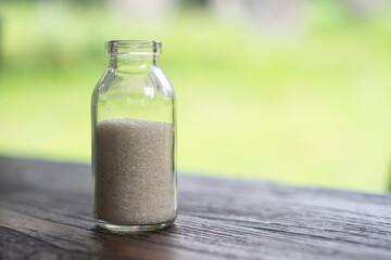 Sugar in the bottle on blur background. Healthy concept