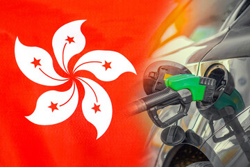 Car with a fuel injector on Hong Kong flag background. Record prices fuel for population. Gasoline price increase during energy and fuel world crisis in Hong Kong