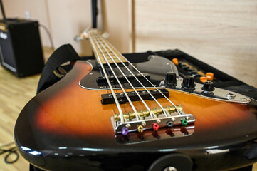 Bass guitar on the stage, close up. Electric bass guitar in studio. Music instrument