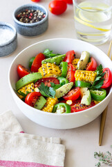 Salad with corn, avocado, tomatoes, peppers and parsley. Healthy eating. Vegetarian food.