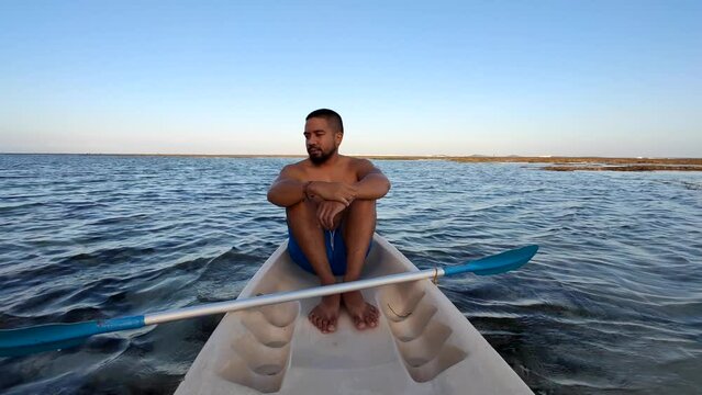 Indonesian Man Canoeing Canoe at Gunung Payung Beach, Bali, Indonesia
