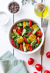 Salad with corn, avocado, tomatoes, peppers and parsley. Healthy eating. Vegetarian food.