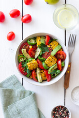 Salad with corn, avocado, tomatoes, peppers and parsley. Healthy eating. Vegetarian food.