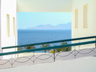 View of the turquoise sea and mountains through the window in the white wall of the hotel, Egypt, Sharm el Sheikh.