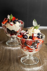 blueberry dessert with strawberries and cream on a dark background. food concept