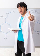Young student chemist in the classroom