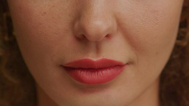 Woman lips and mouth in motion with red lipstick