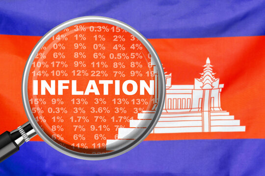 Magnifying glass focused on the word inflation on Cambodia flag background. Hike interest rate. Inflation income crisis. Inflation, tax, cash flow and another financial concept in Cambodia