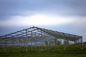 The building of the new base for cows. Steel structure of the future truss.
