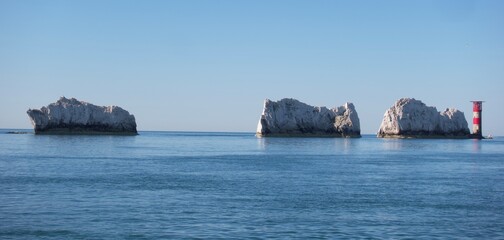 The Needles lighthouse filmed from a yacht on a very calm sunny day plus 2 of the chalk stacks on the Isle of Wight close to Alum Bay and Totland Bay.