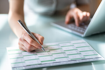 Woman At Desk Arranging Holiday Days