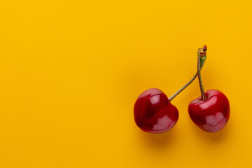 Cherry berries on a pastel background top view.  Background with a cherry on a sprig, flat lay