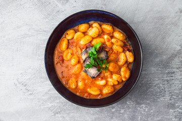 healthy plant-based food, vegan potato gnocchi with bell pepper sauce and ashed cashew cheese