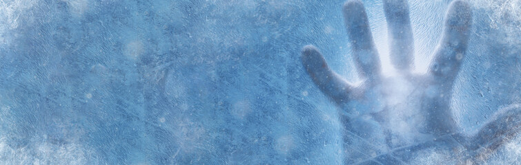 Banner of human hand against frozen glass and blue background. Energy Crisis Concept. Cold winter 2022