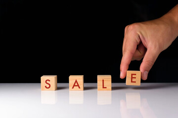 Sale during promotional periods, wooden cubes labeled SALE. Product discounts, promotional events during festivals, product trading, e-commerce, discount coupons, online trading. with copy space.