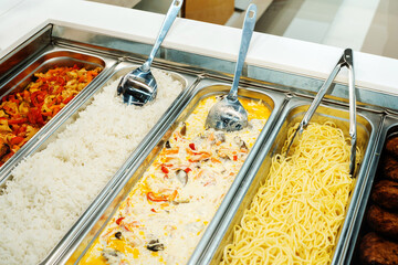 Metal trays with food in a fast food restaurant. Vegetarian food in the community cafeteria. selective focus