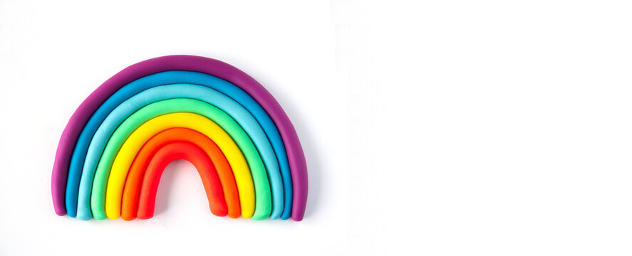 Banner of a colorful rainbow of plasticine on white background. Made from plasticine. Isolate