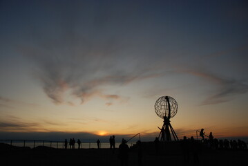 A beautiful evening sky over a globe on North Cape / Nordkapp, Norway