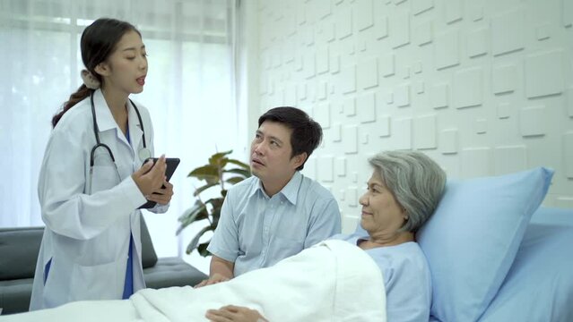 Doctor talking to asian elder patient.