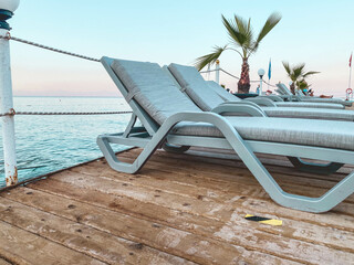 hot, tropical country with sea and mountains. wooden pontoon for diving into the water. on the...