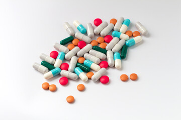 Scattered pills isolated on a white background, space for text, top view.
