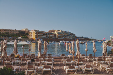 Obraz premium beach sun beds at golden hour