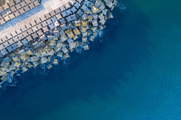 aerial view of a granite block breakwater, harbour seawall