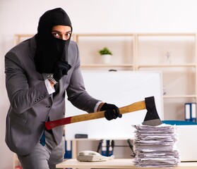 Male gangster stealing information from the office
