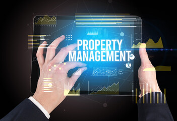 Close-up of hands holding tablet with business inscription