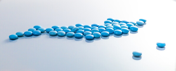 blue pills on white background. Sport doping, erection, concept