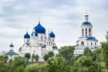 Fototapeta na wymiar Blue domes of Holy bogolyubovsky monastery against cloudy sky