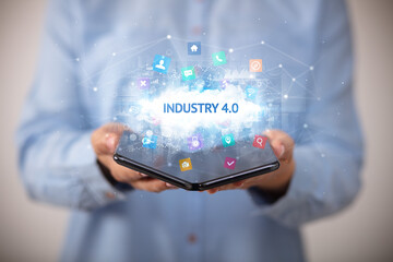 Businessman holding a foldable smartphone, technology concept