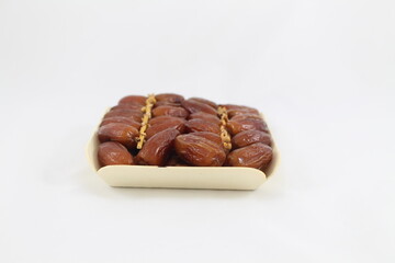 Cardboard tray of date fruits on grey background