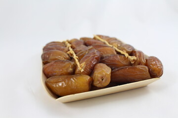 Cardboard tray of date fruits on grey background