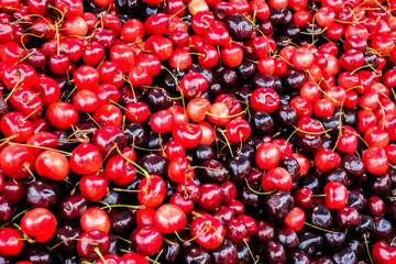 A bunch of red cherries for sale at a summer roadside stall.